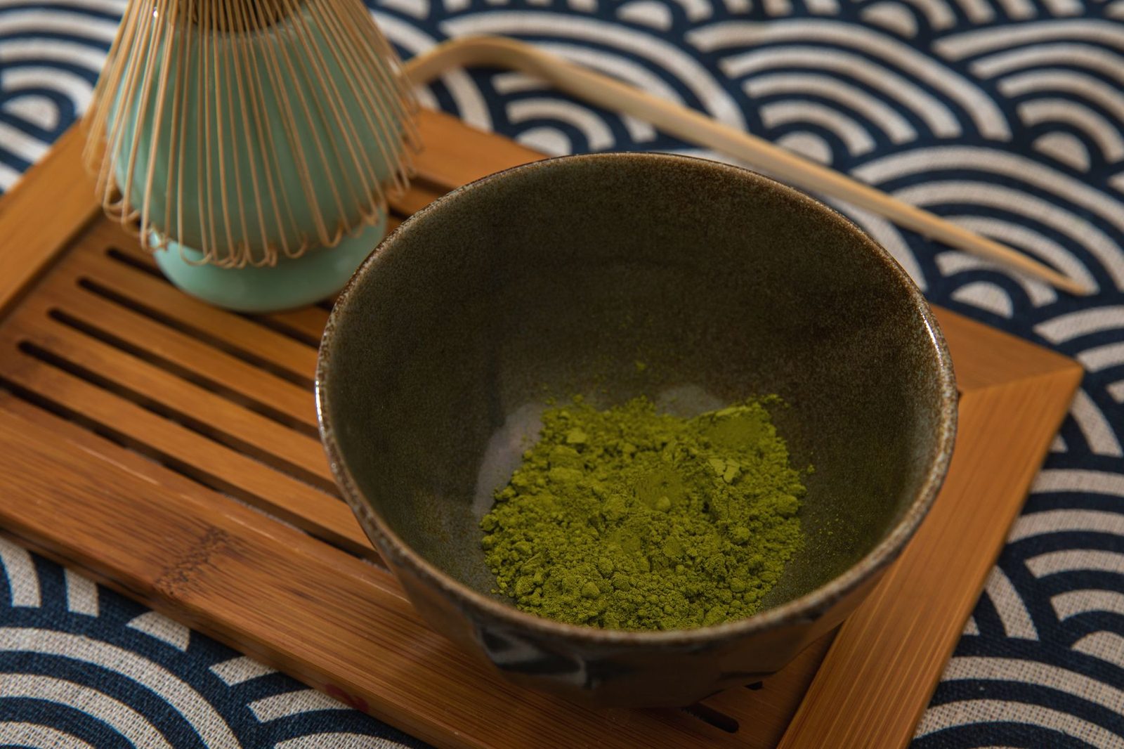 A traditional matcha set with bowl, whisk and scoop laid out together