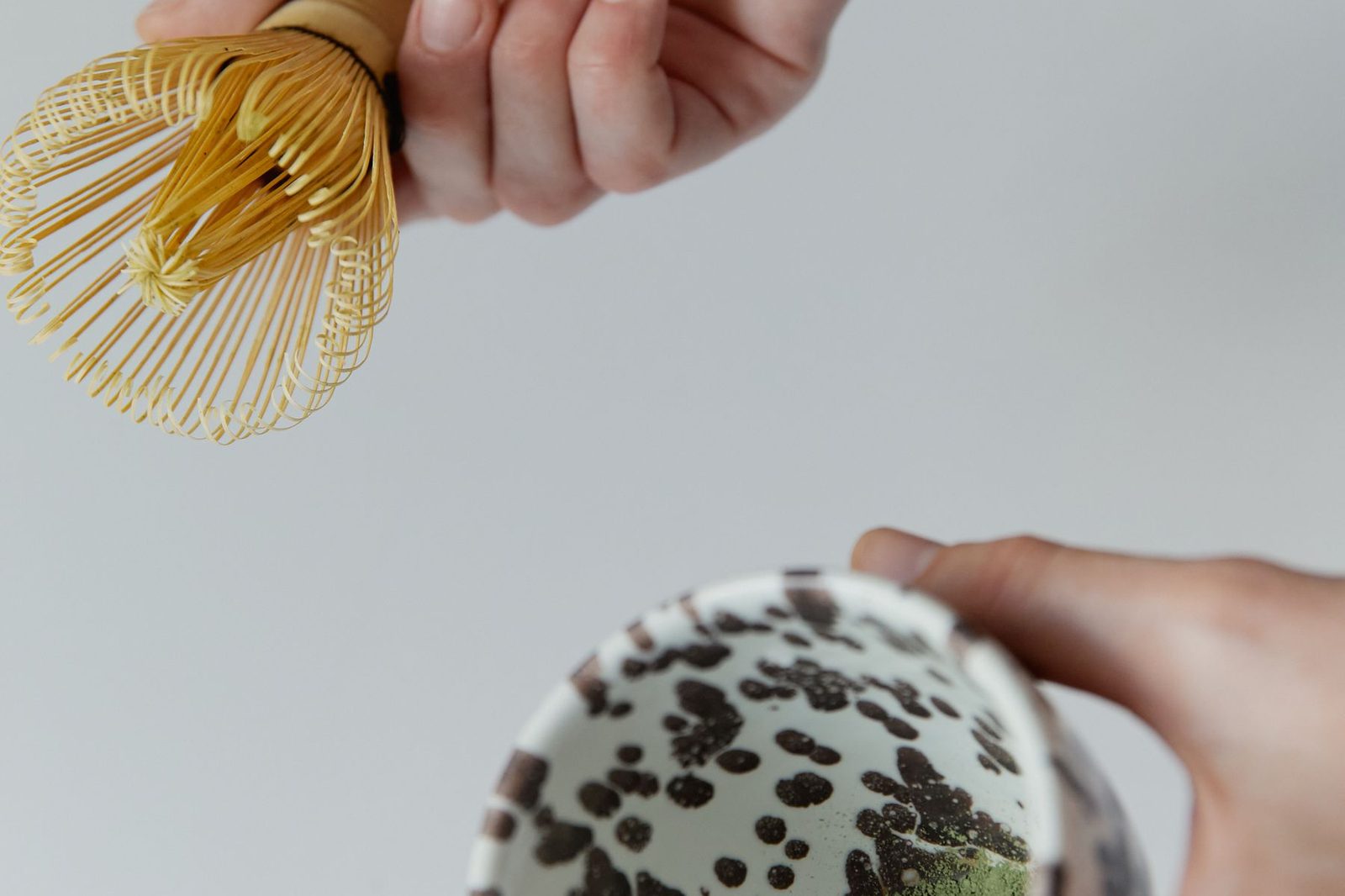 Whisking matcha with a bamboo chasen