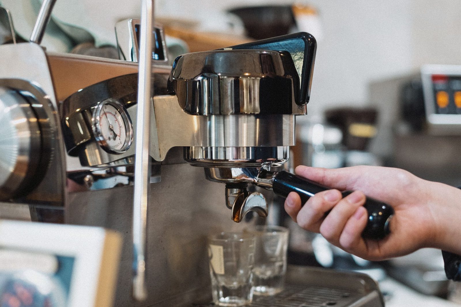 Barista locking a portafilter into an espresso machine