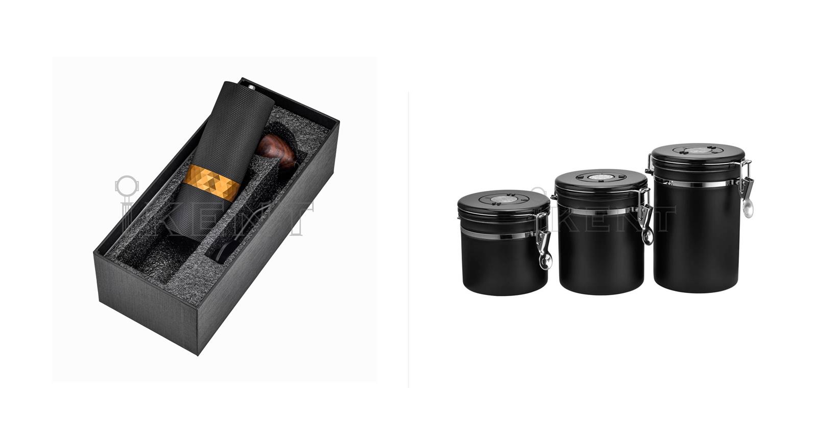 A retail gift box containing a manual grinder beside a range of black coated canisters