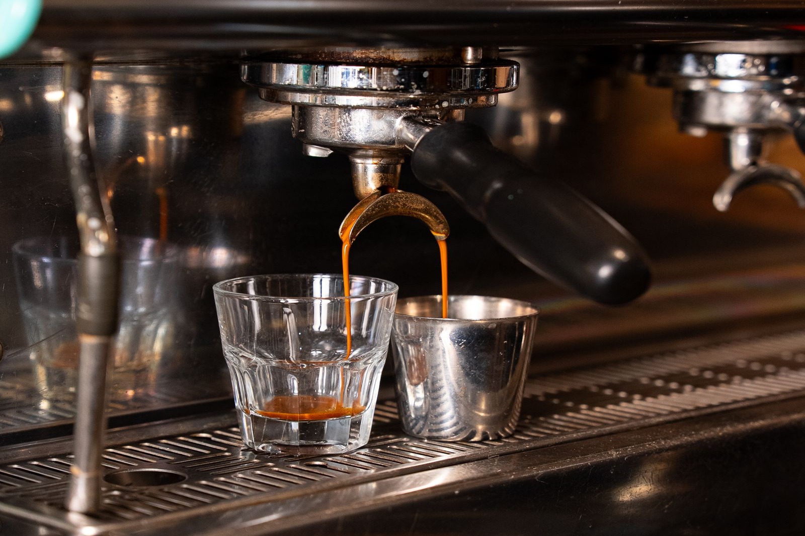Espresso machine extracting a shot into a cup on a counter