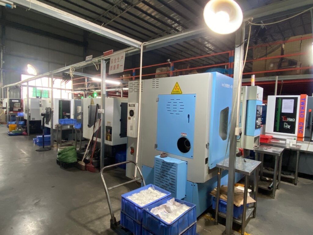 Row of CNC machining centres cutting stainless steel coffee tool parts at the iKentcoffee factory